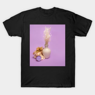 beauty set with  candle, soap and dried flowers  on a violet background T-Shirt